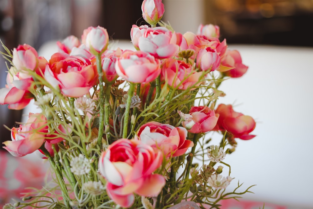 a vase filled with lots of pink and white flowers