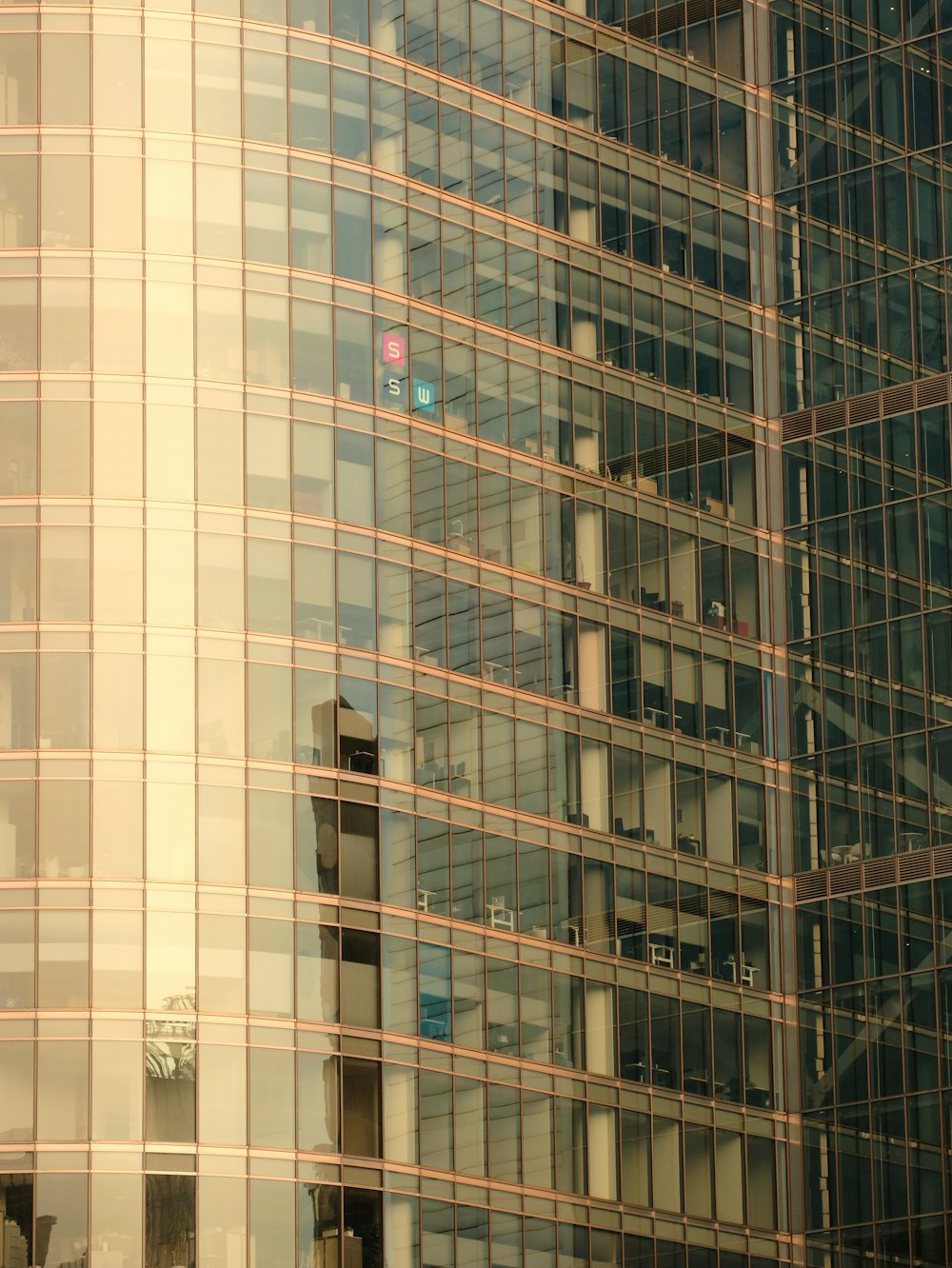 a tall building with lots of windows next to a traffic light