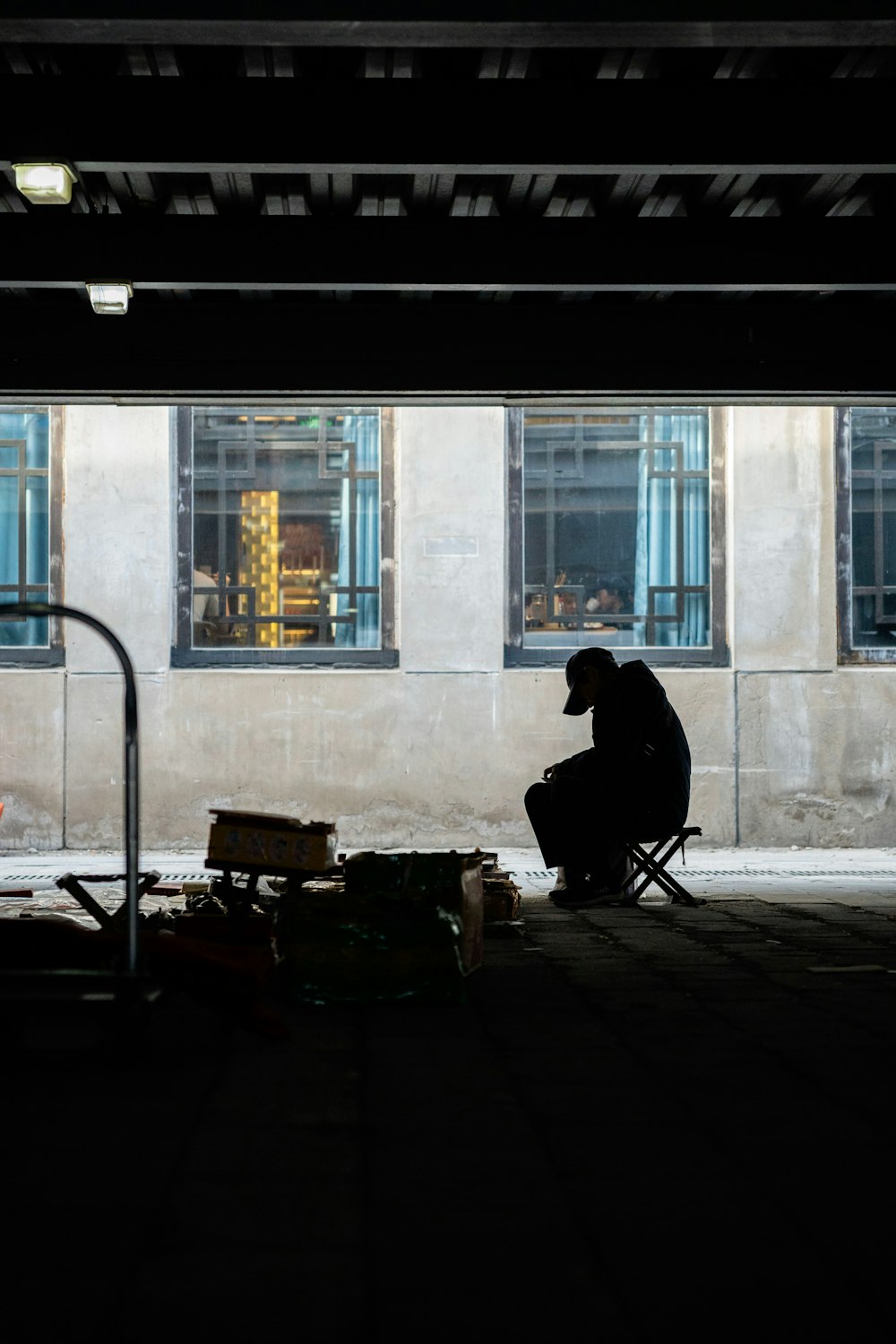 a person sitting on a chair in a dark room