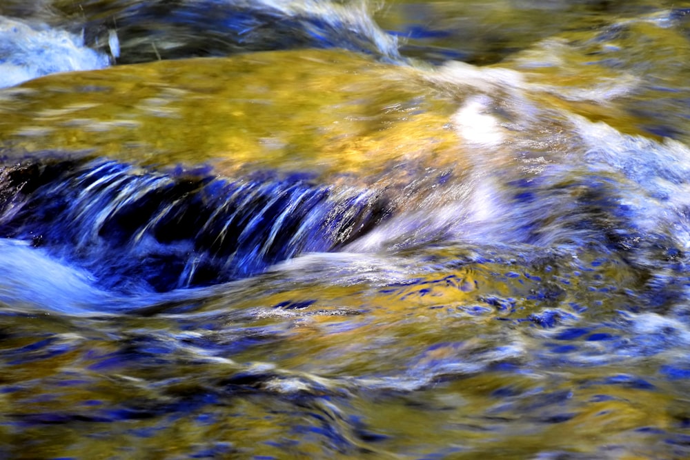 a stream of water flowing over rocks in a stream
