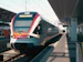 a train pulling into a train station next to a platform