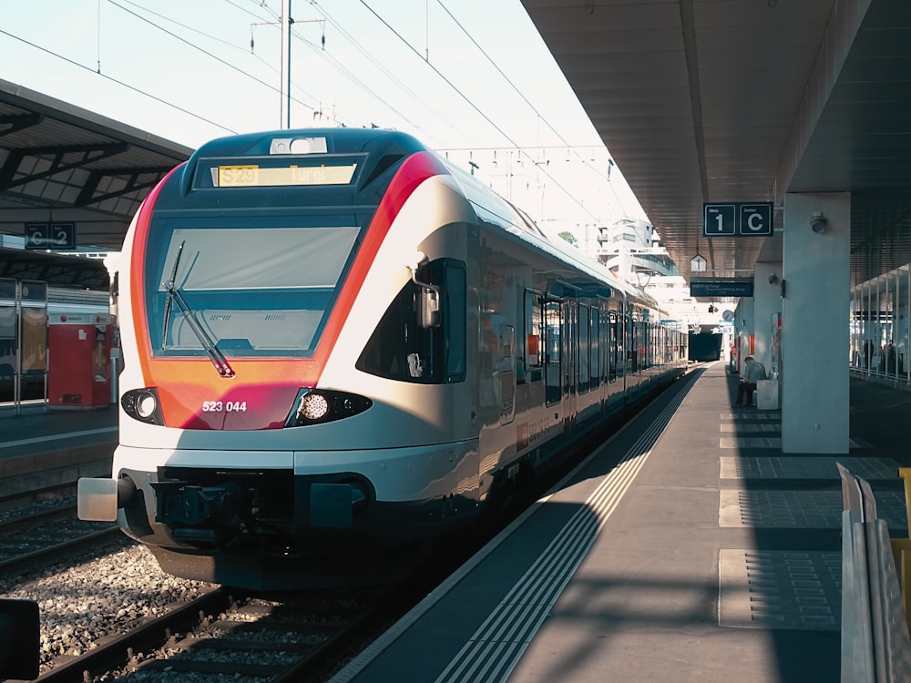 a train pulling into a train station next to a platform