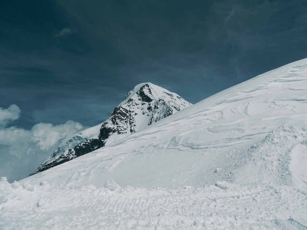 a man riding skis down the side of a snow covered slope