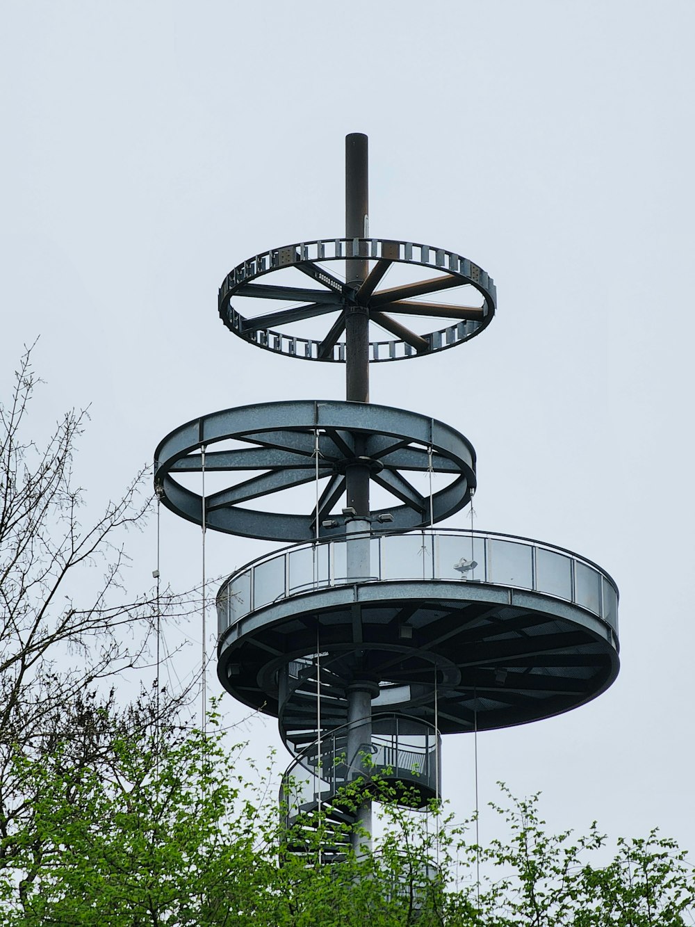 a tall metal structure with a clock on top of it