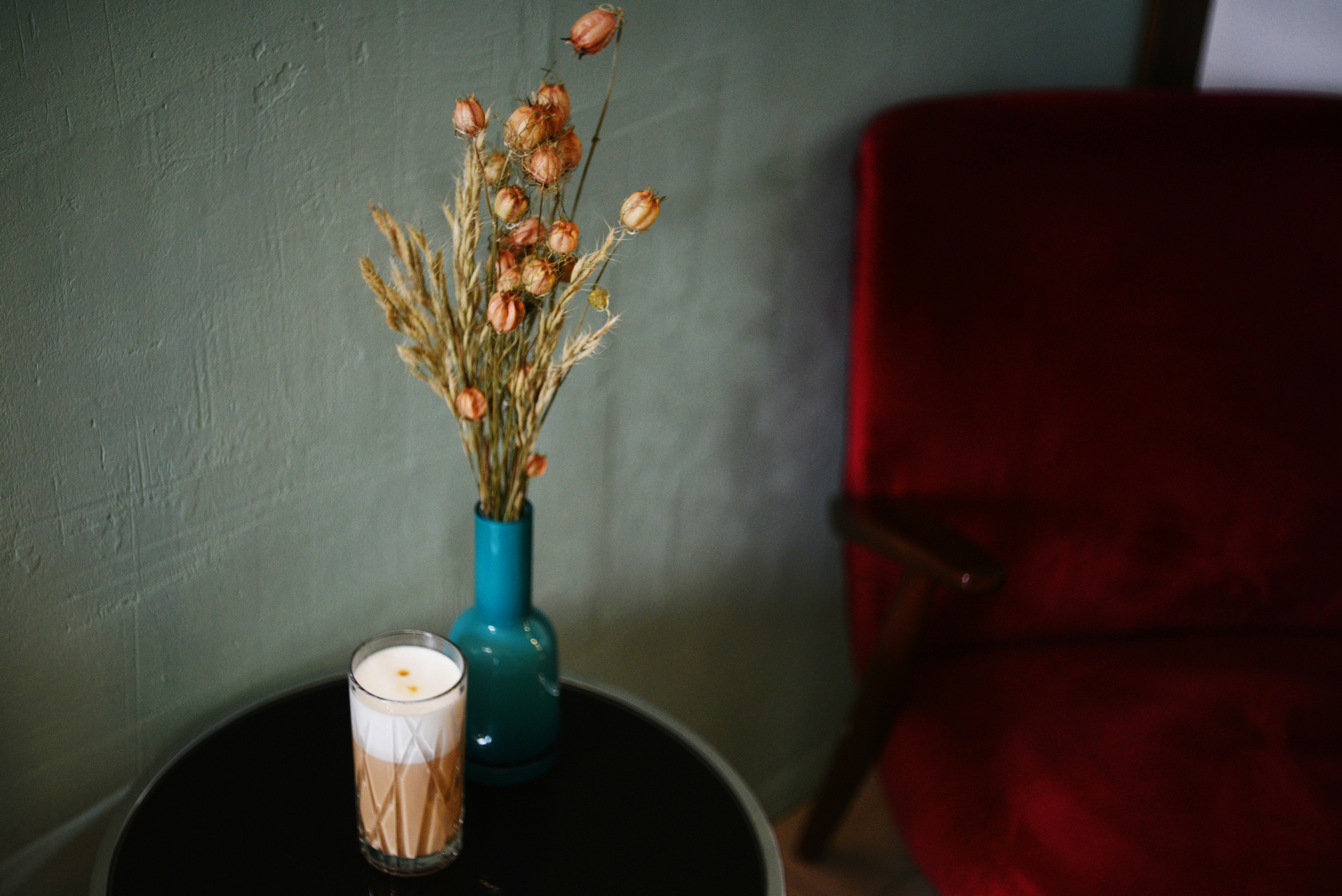 Cozy coffee interior with flowers and candle