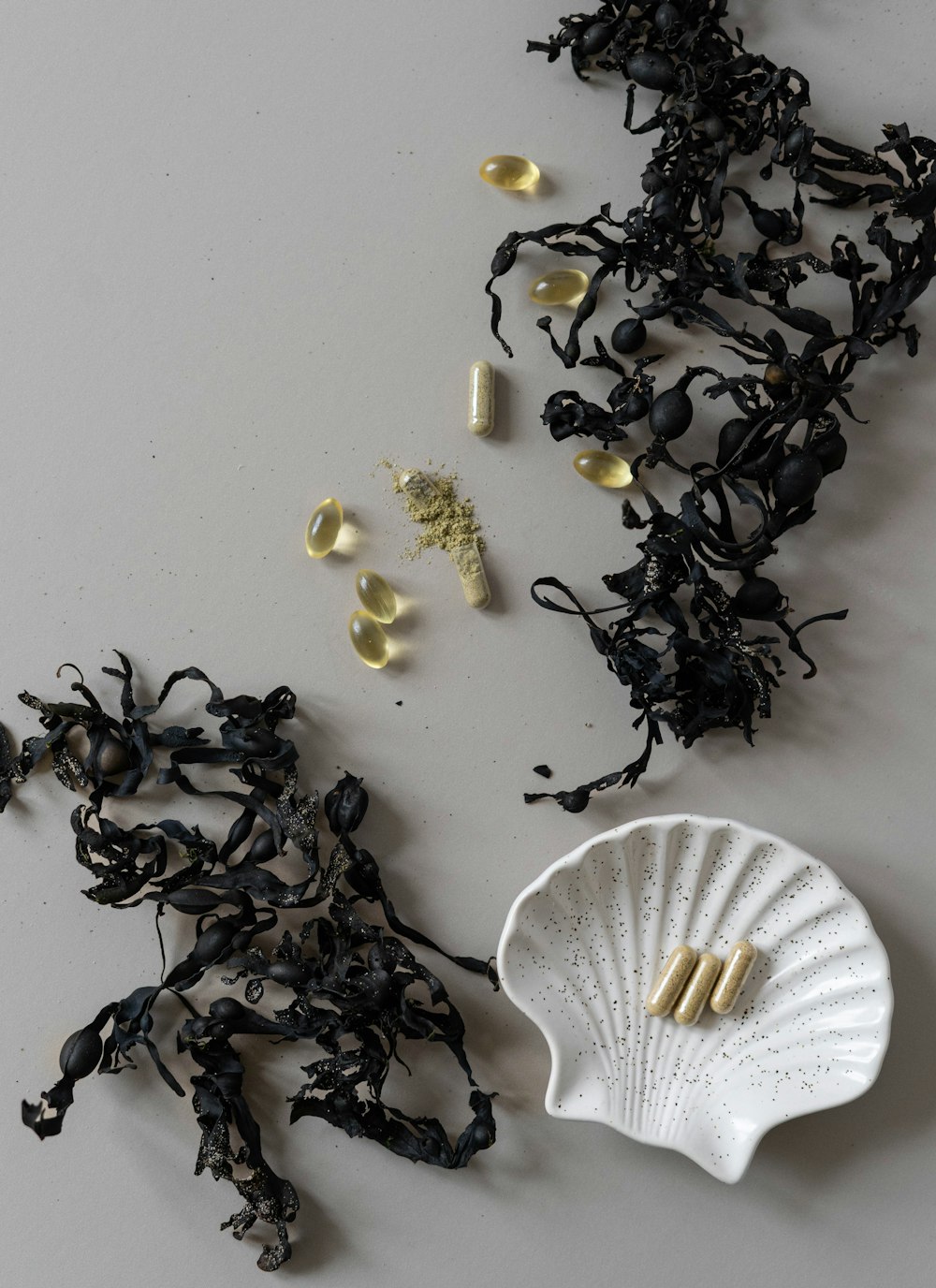 a pile of black and white tea next to a white plate