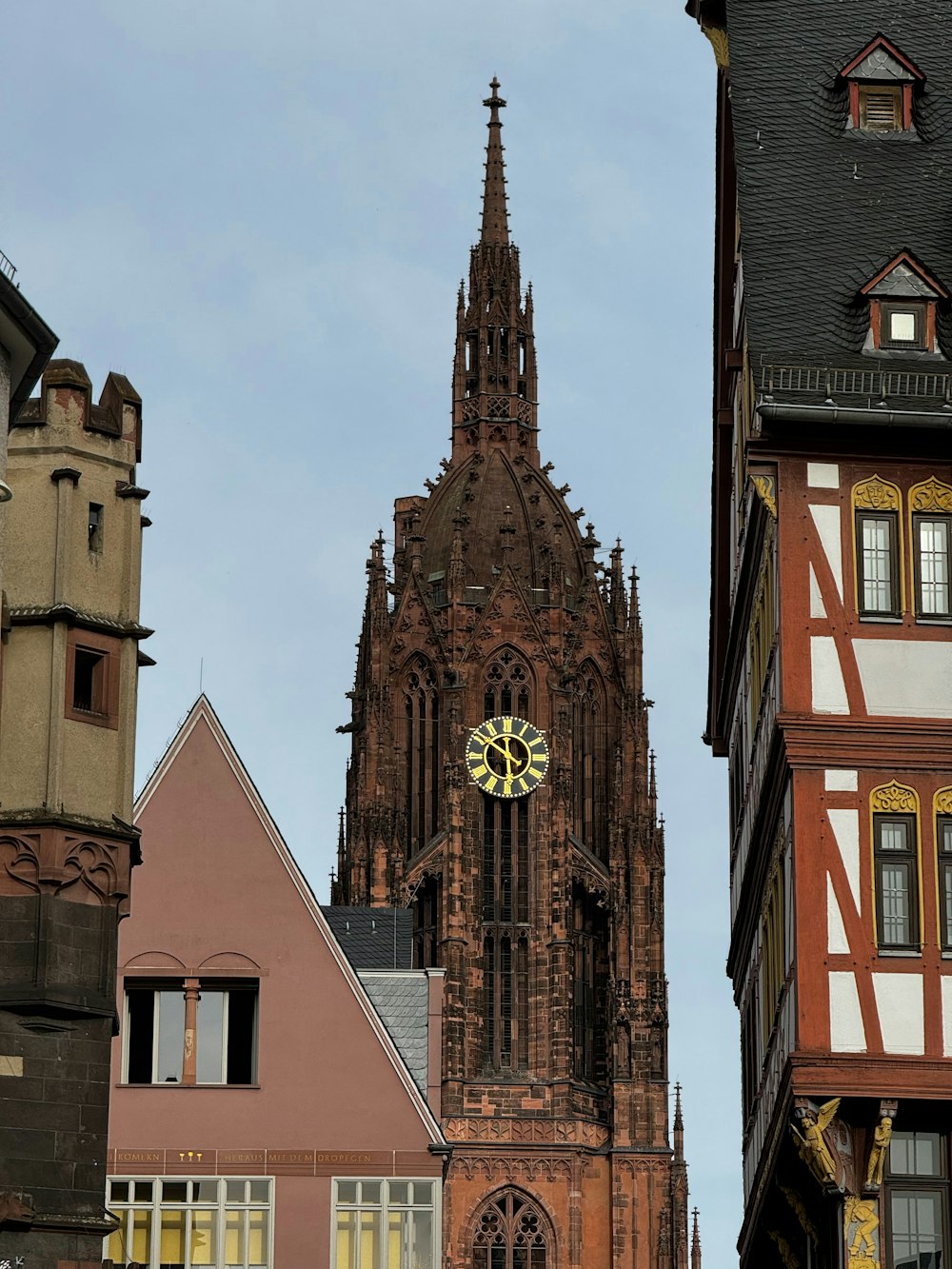 a clock on the side of a tall building