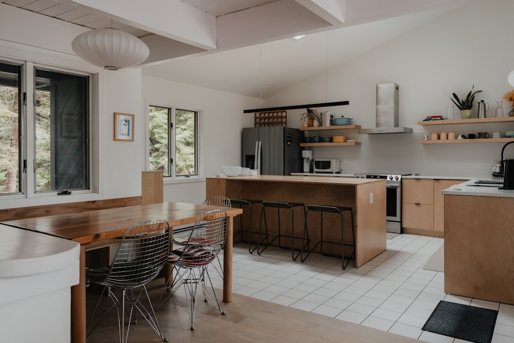 a kitchen with a table, chairs, and a refrigerator