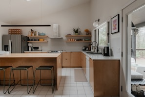 a kitchen with a lot of counter space and stools