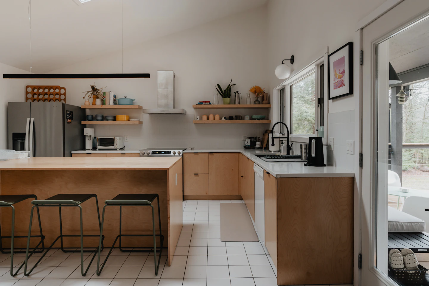 An open kitchen and dining space with stools around the counter