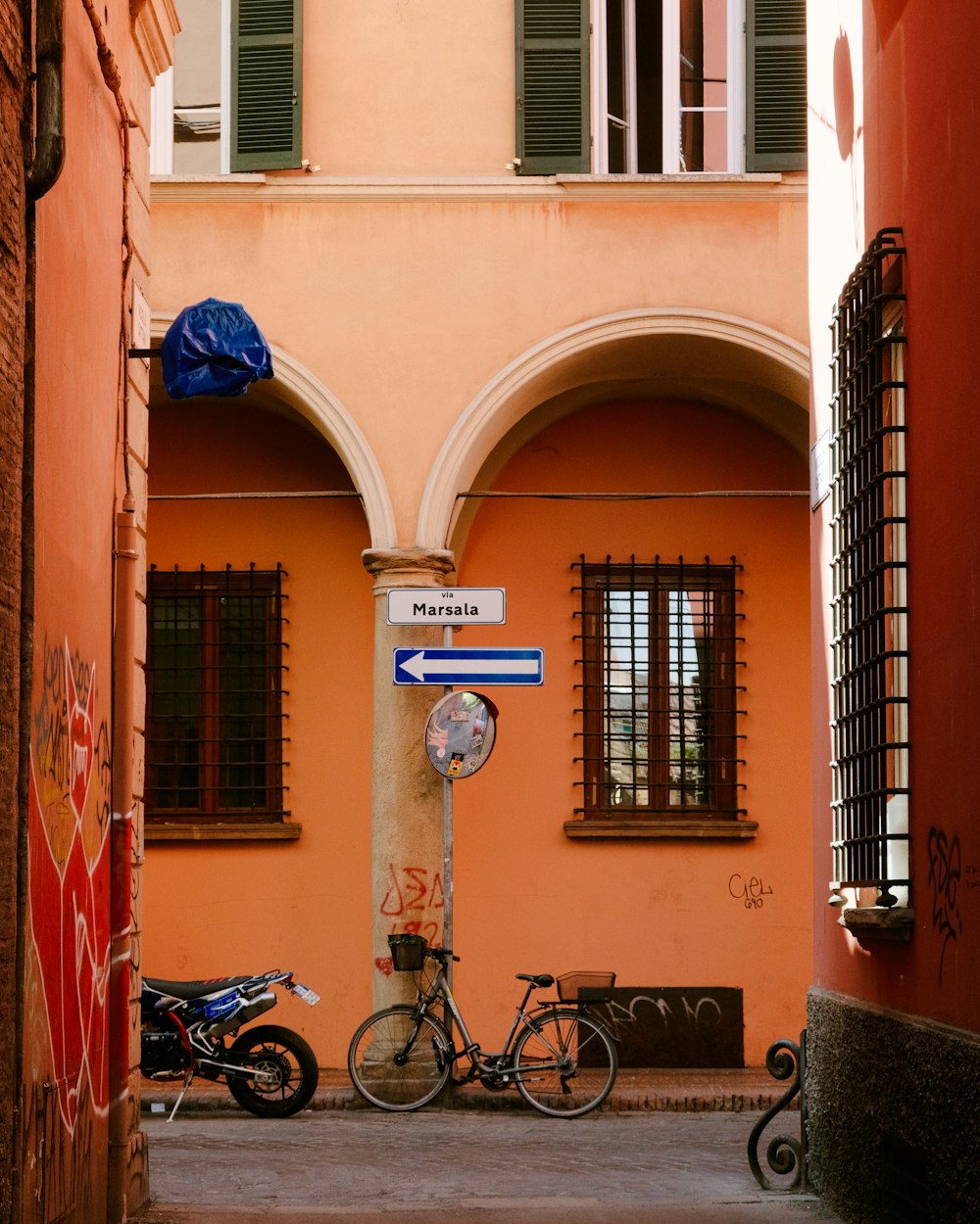 a bike parked next to a pole with a clock on it