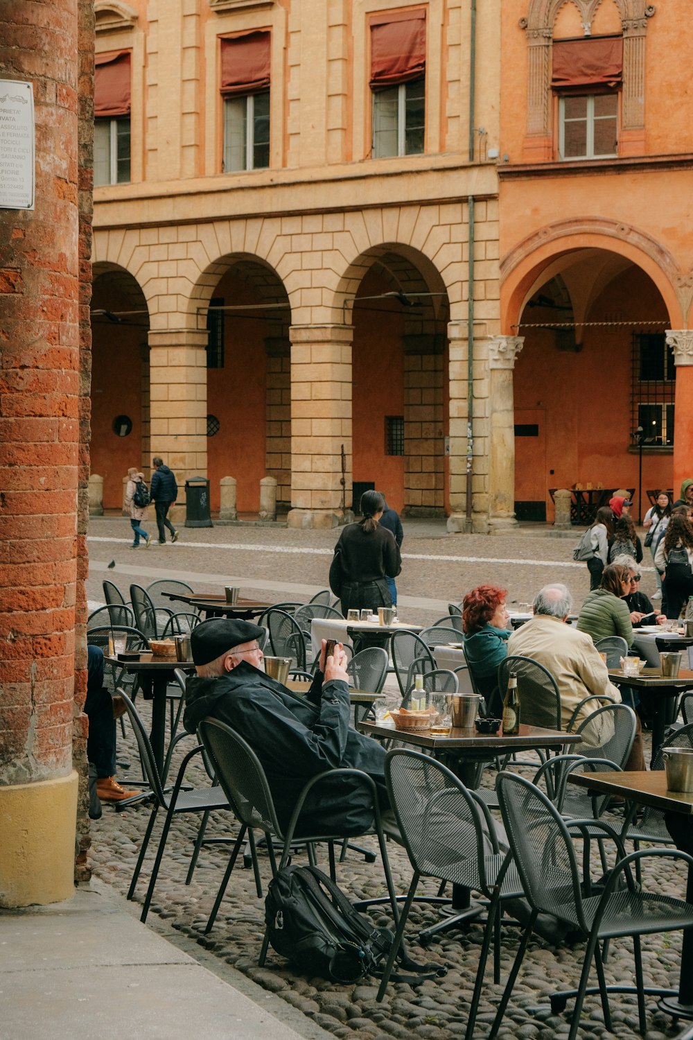 a group of people sitting at tables in front of a building