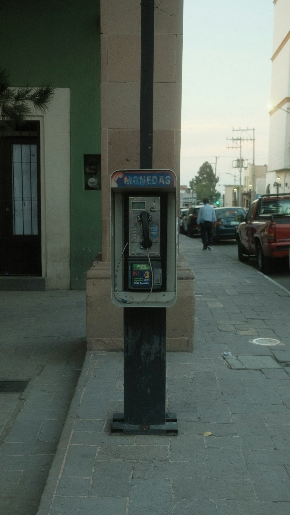 a parking meter sitting on the side of a street