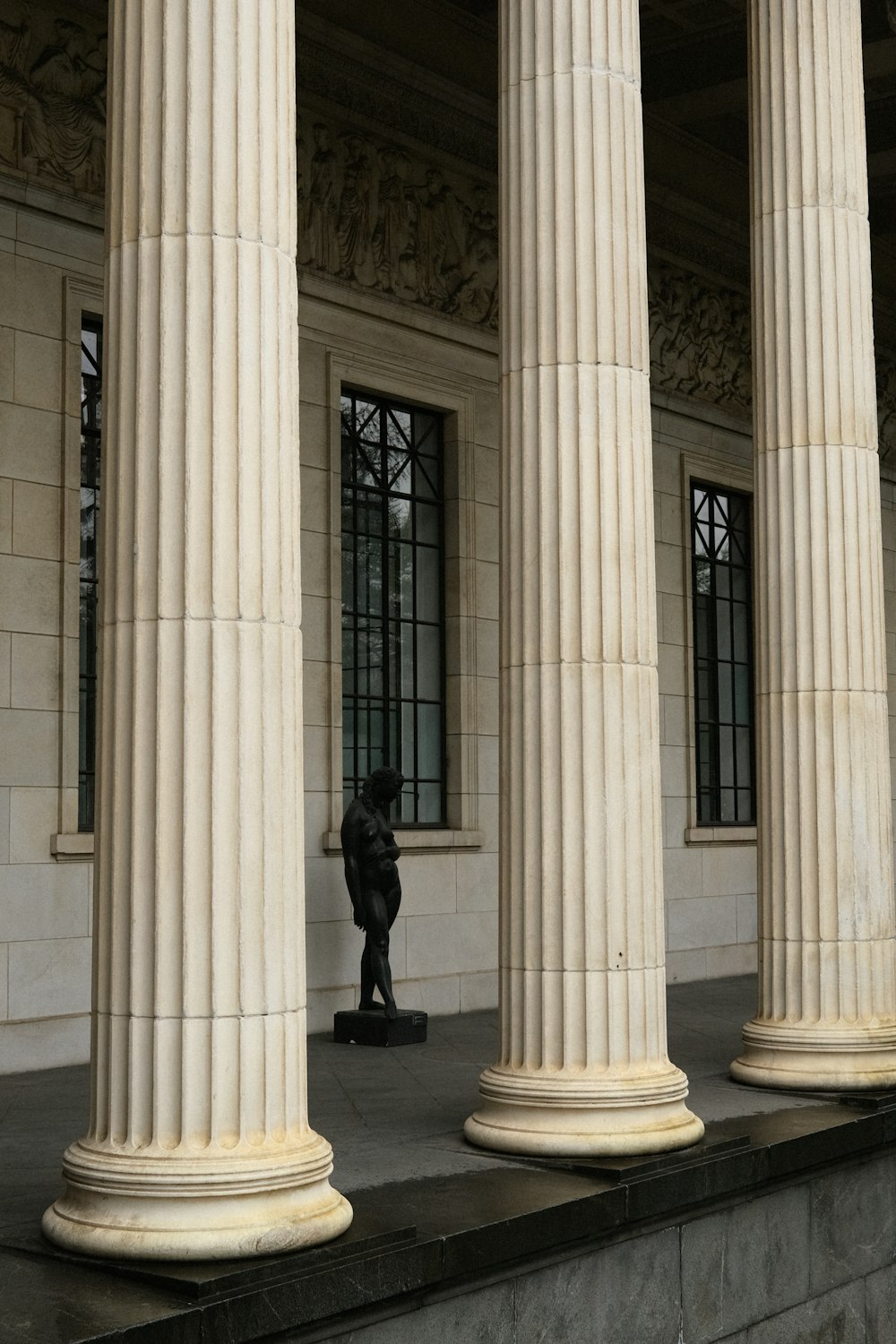 a person standing in front of a row of pillars