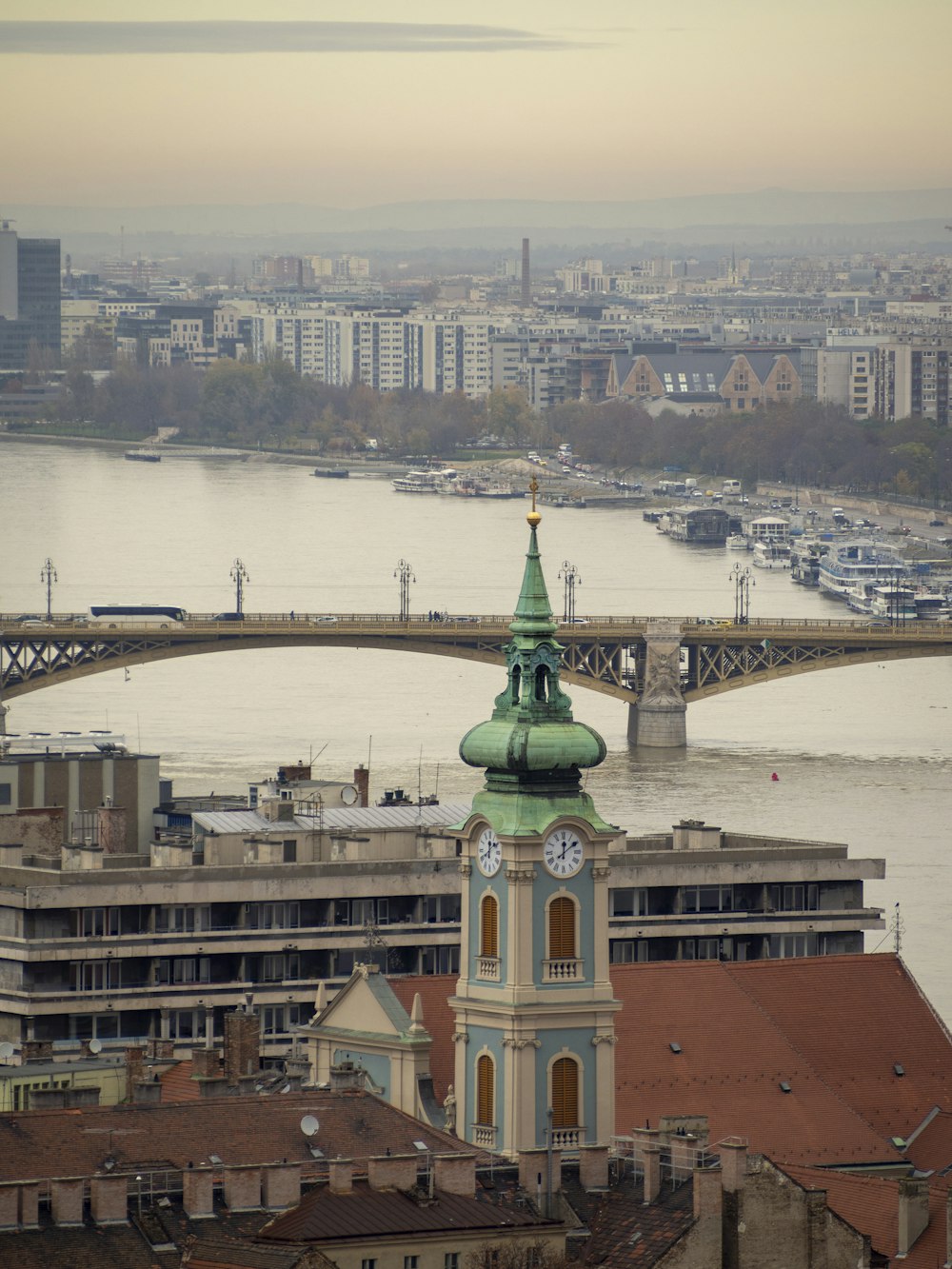 a view of a city with a bridge and a clock tower