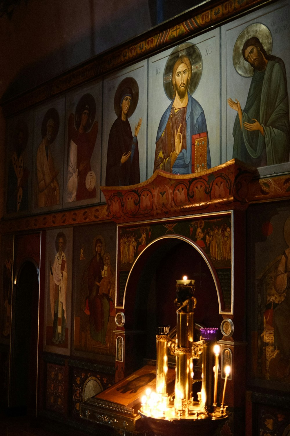 a church altar with candles lit in front of it