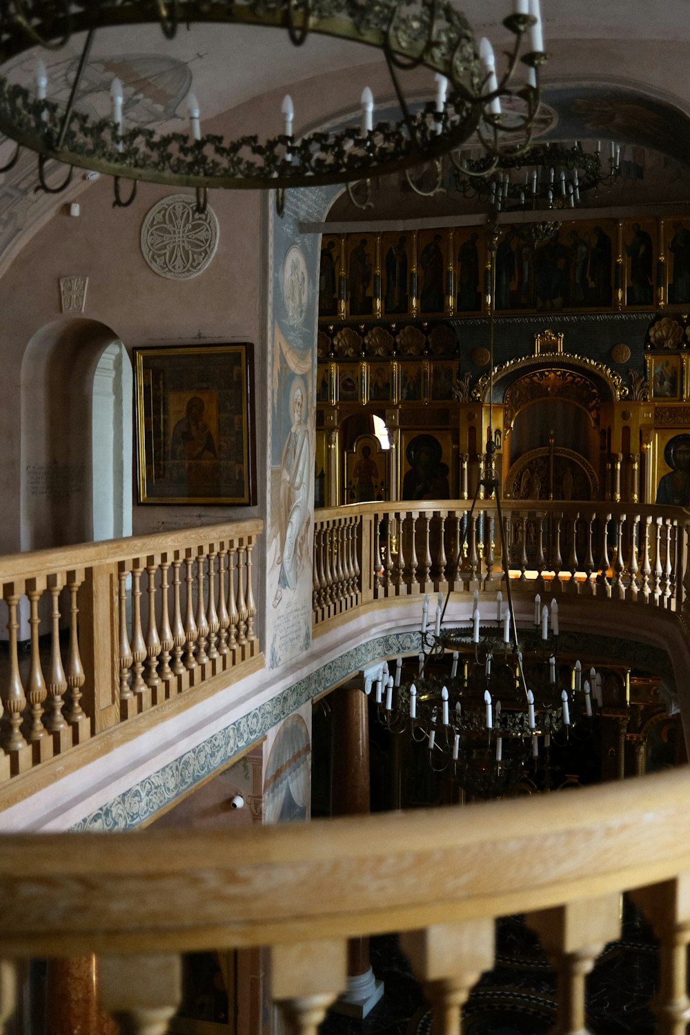 a staircase in a building with a chandelier hanging from the ceiling