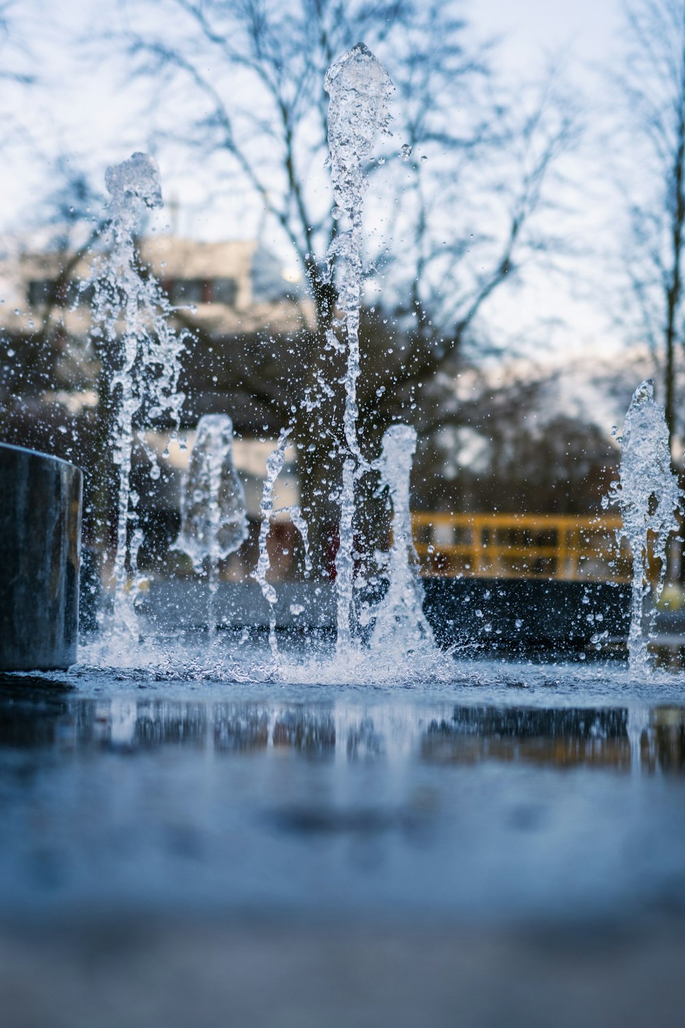 a water fountain with a school bus in the background