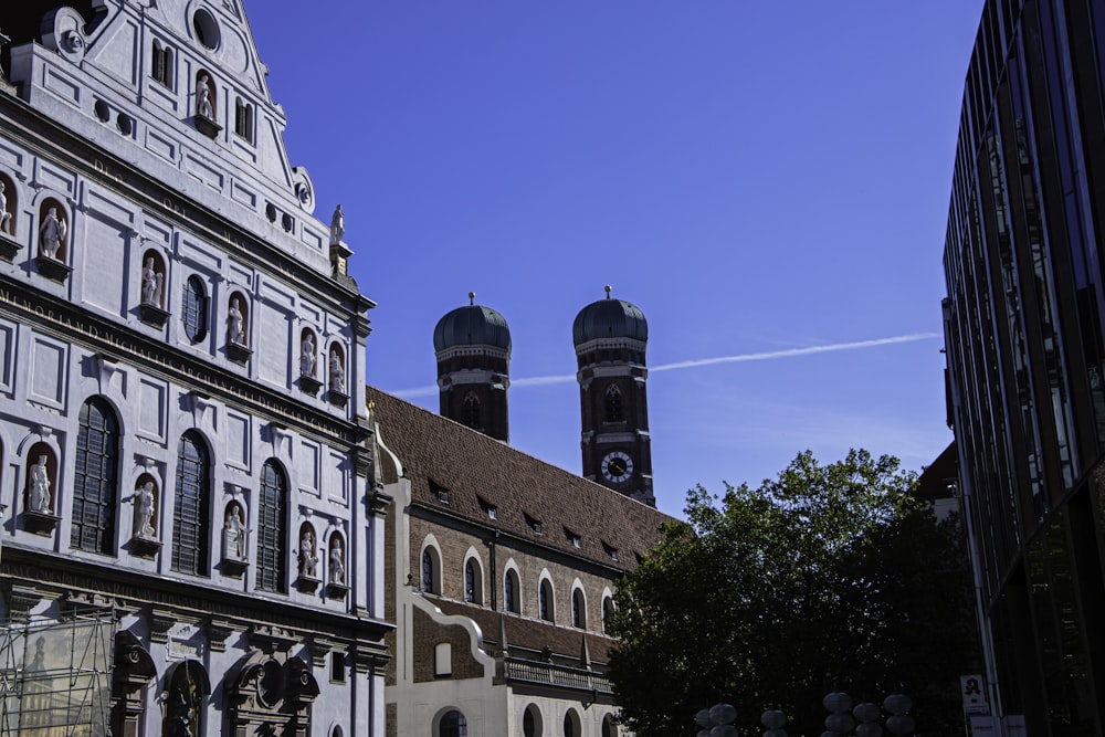 a building with two towers and a clock tower