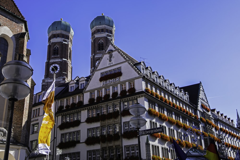 a tall building with a clock tower next to other buildings