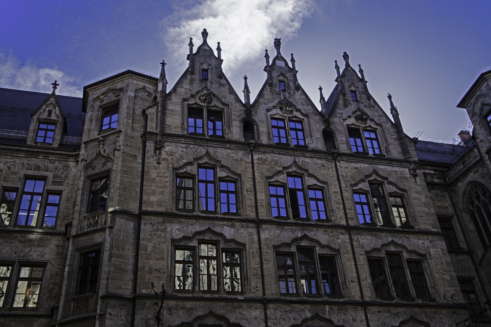 a large building with many windows and a sky background