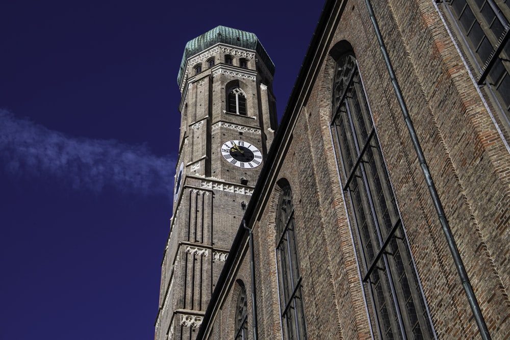 a tall brick building with a clock on it's side