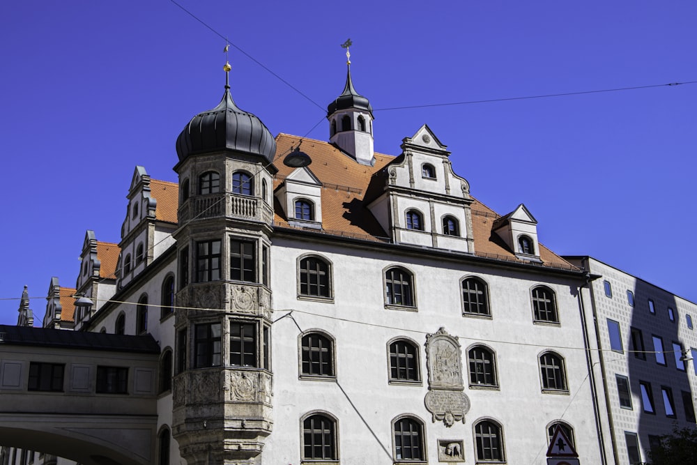 a large white building with a clock tower