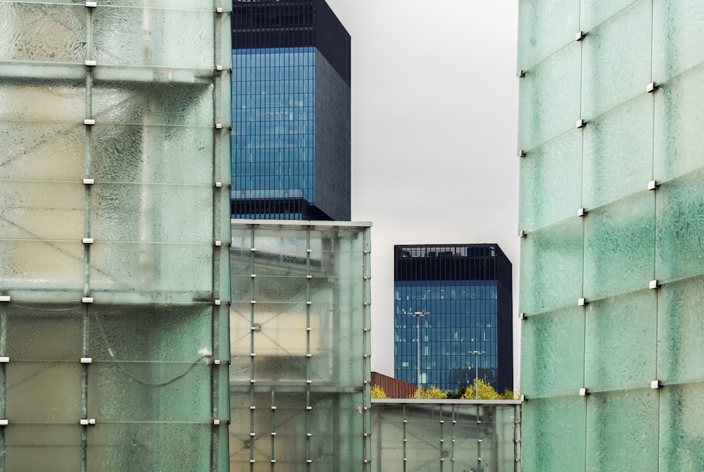 a couple of tall buildings sitting next to each other