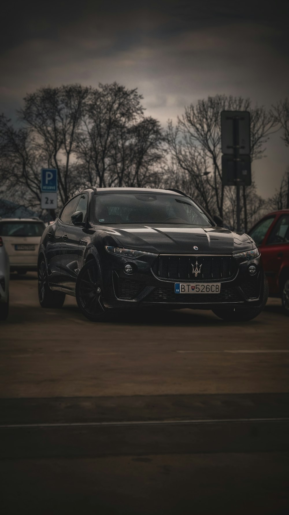 a black sports car parked in a parking lot