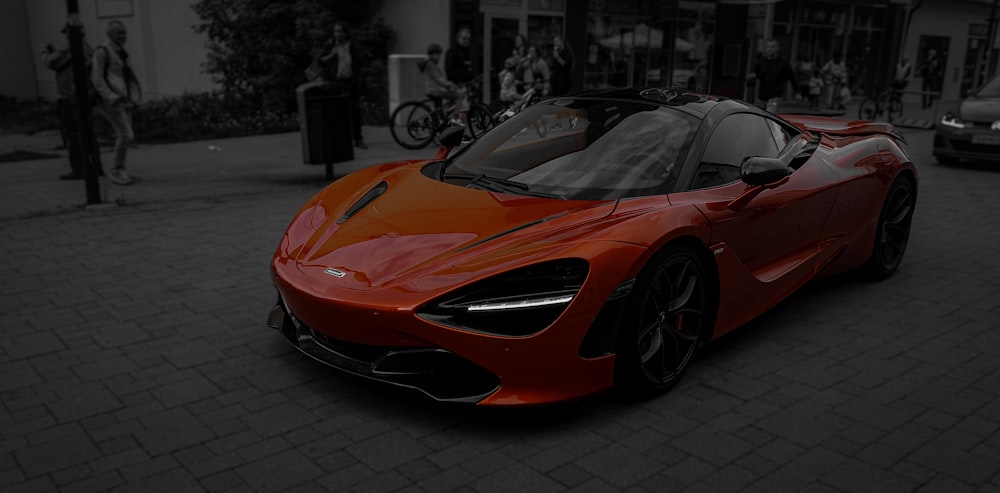 a red sports car parked in front of a building