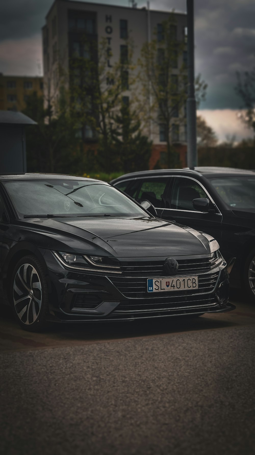 two cars parked next to each other in a parking lot