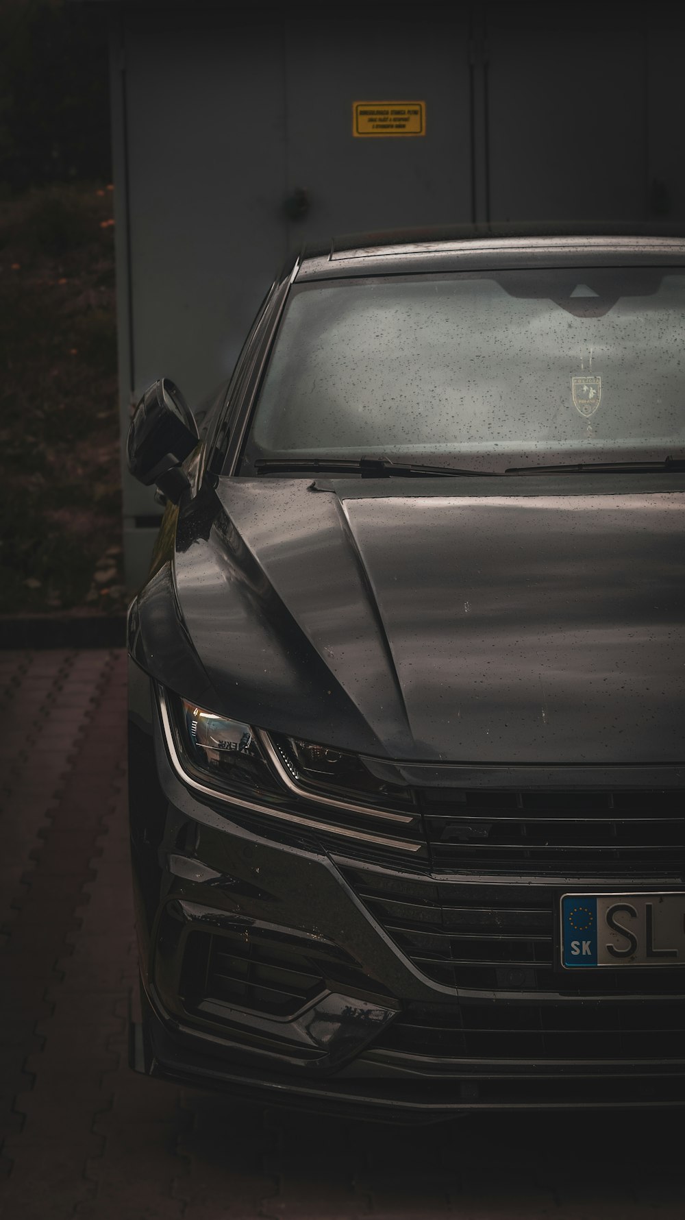 a black car parked in front of a building