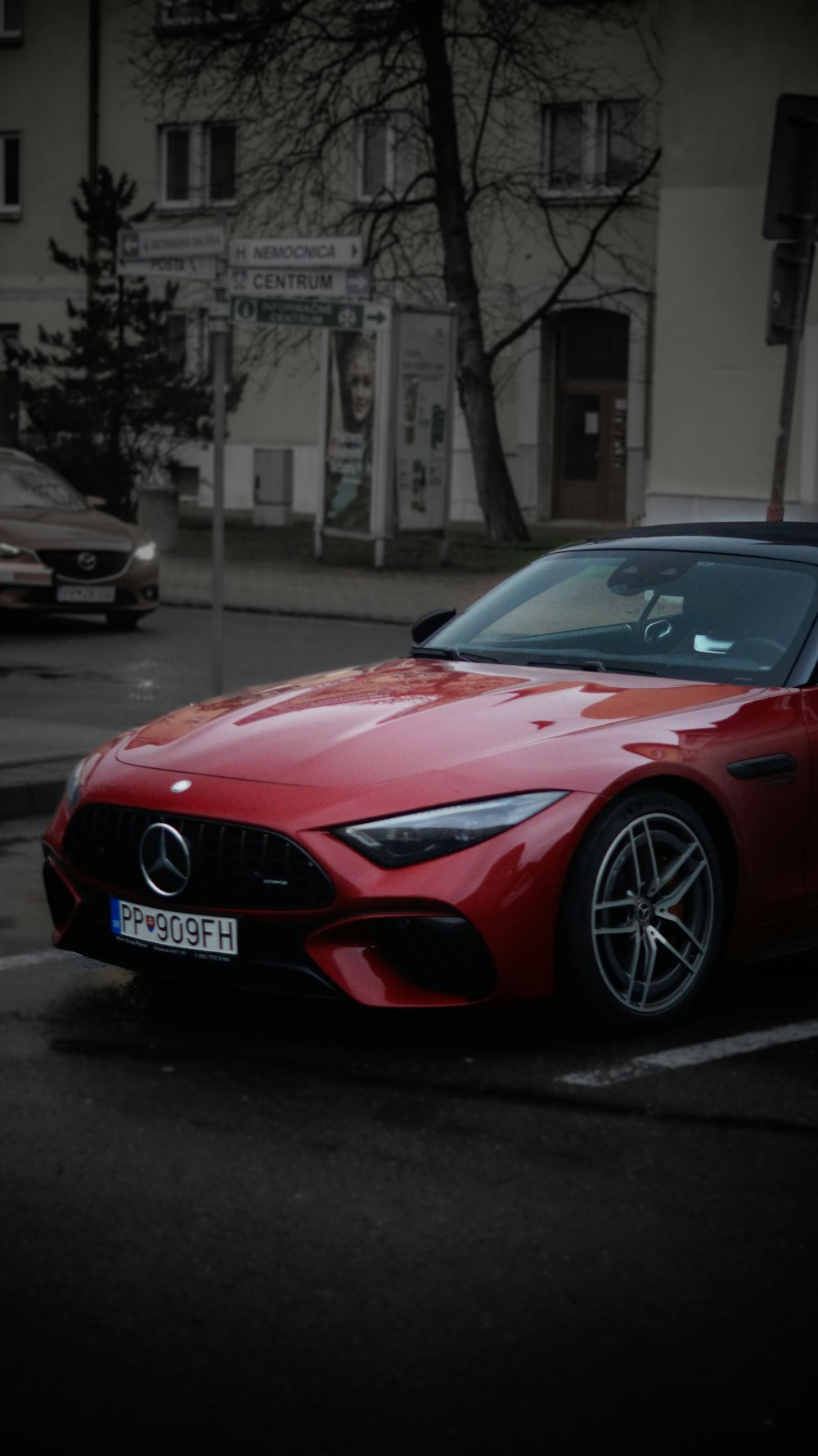 a red sports car parked in a parking lot