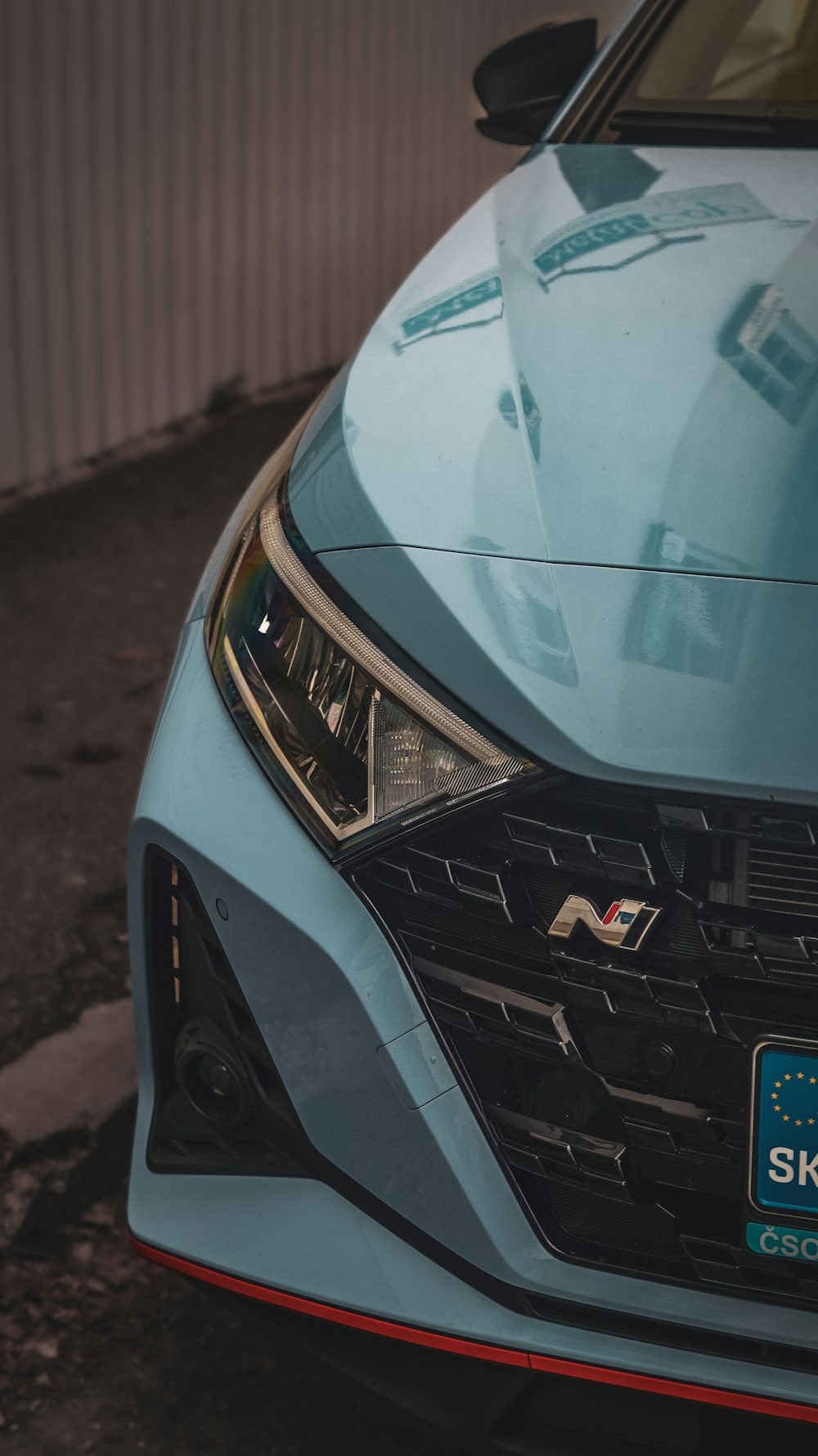 a close up of the front of a blue car