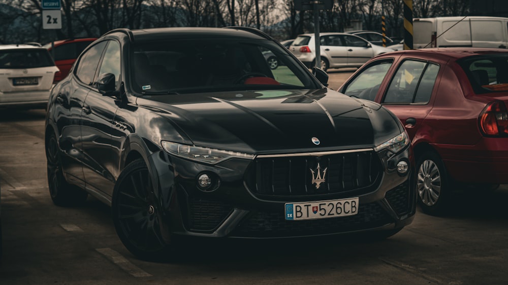 a black masera parked in a parking lot