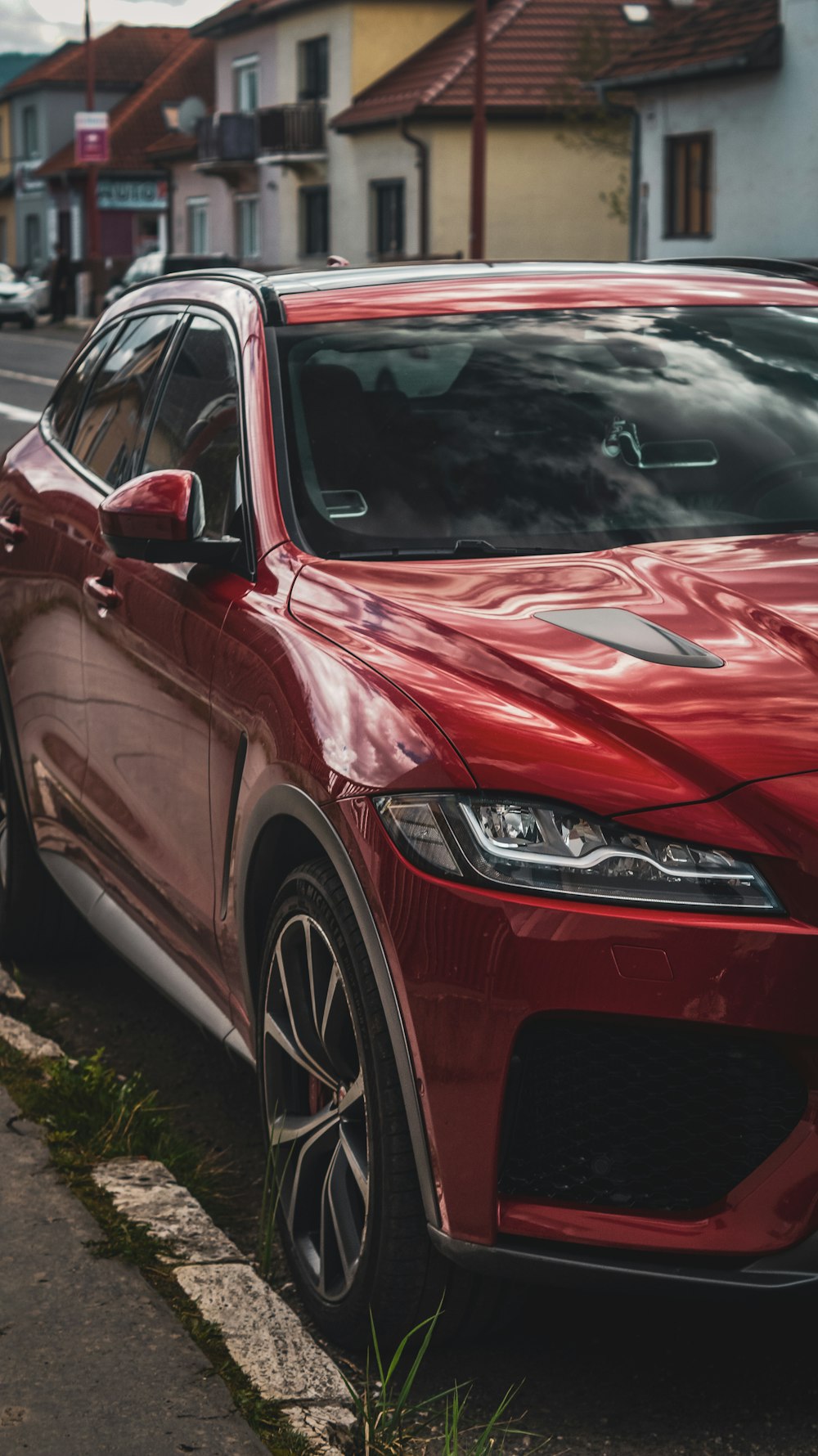 a red car parked on the side of the road