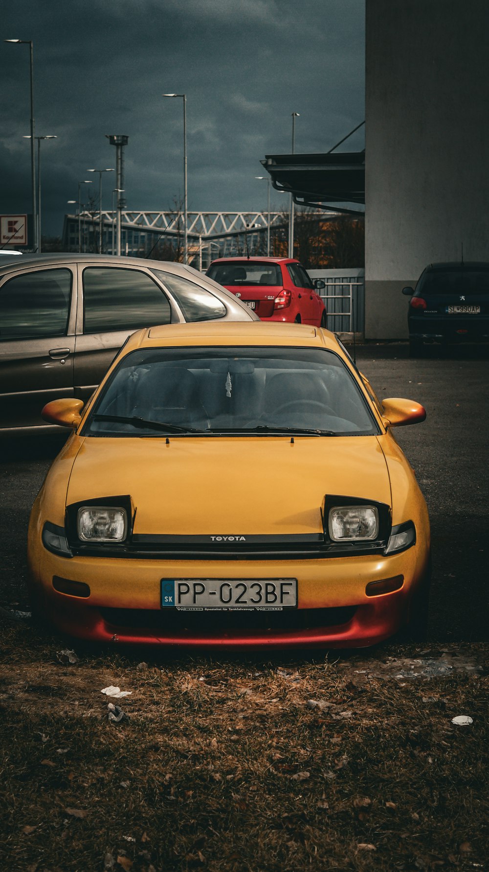 a yellow car parked in a parking lot