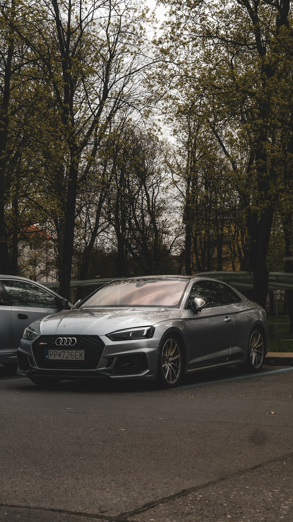 a silver car parked on the side of a road