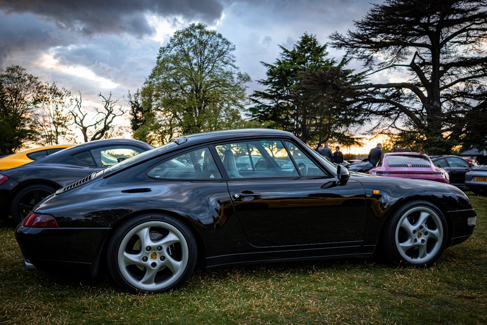 a black sports car parked in the grass