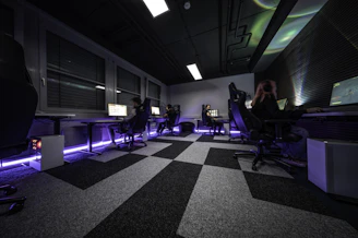 a group of people sitting at desks in a room