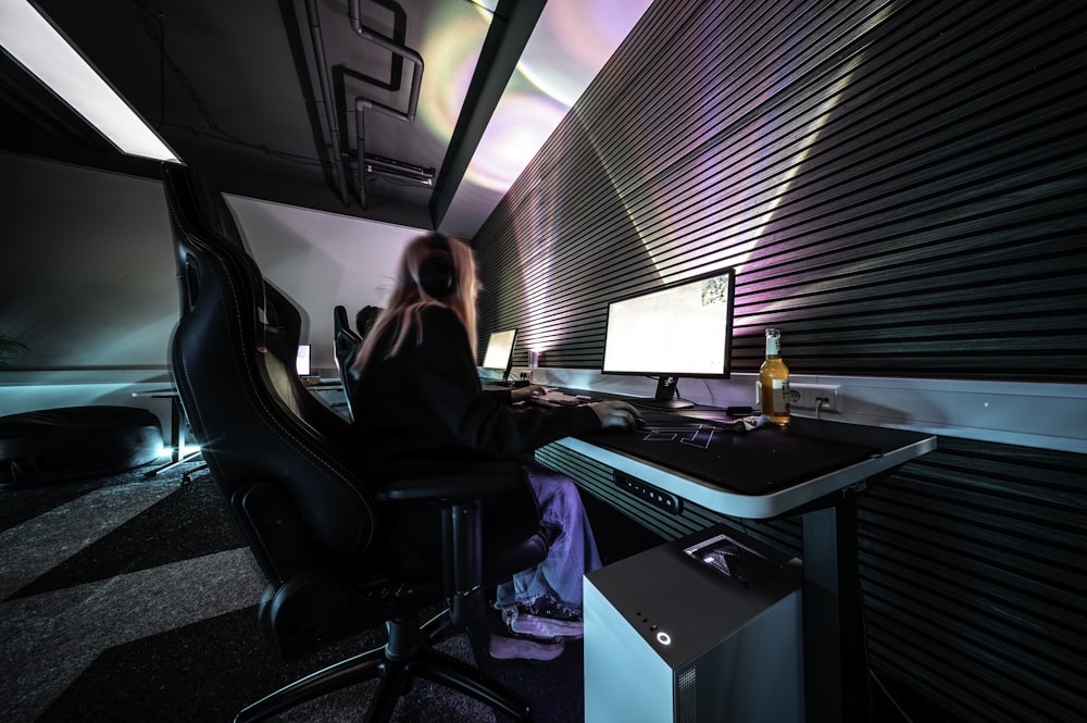 a person sitting at a desk with a computer