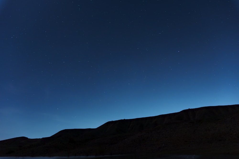 a view of the night sky over a body of water