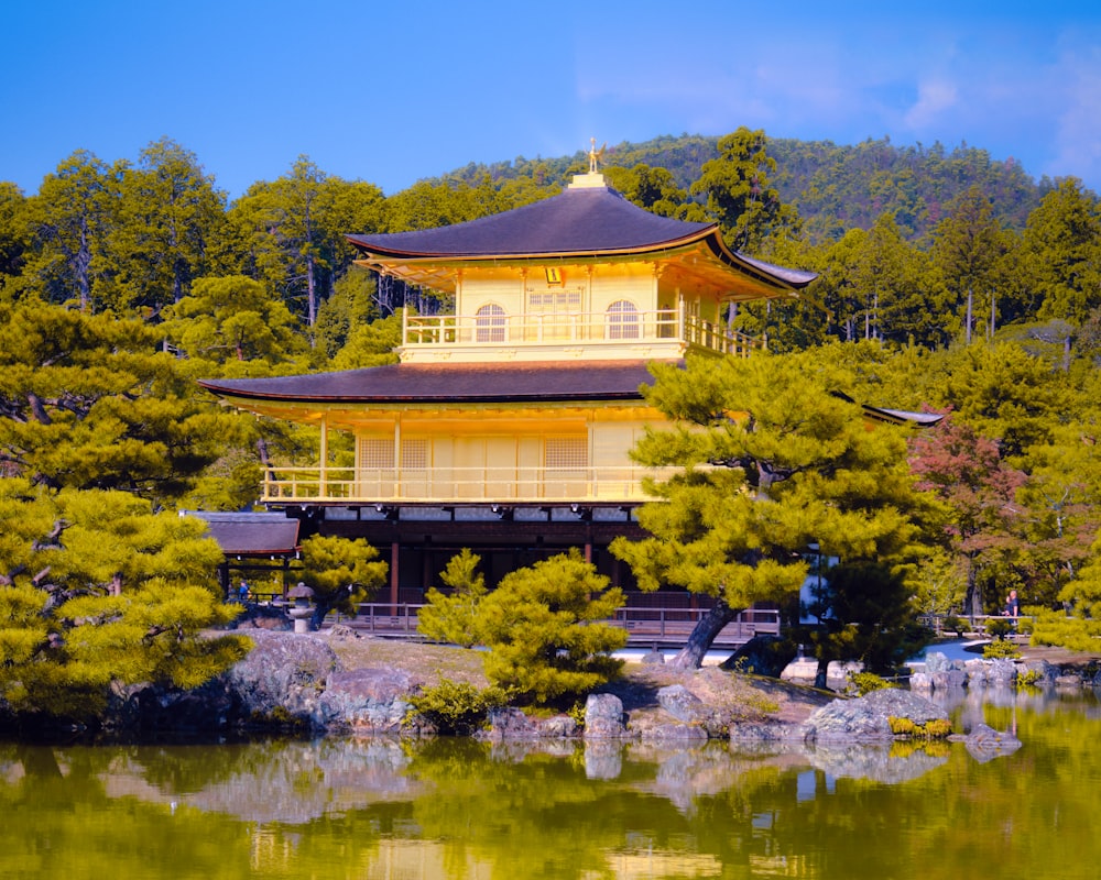 a building with a yellow roof near a body of water