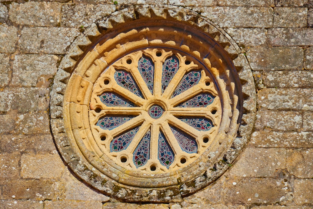 a circular window in a stone wall