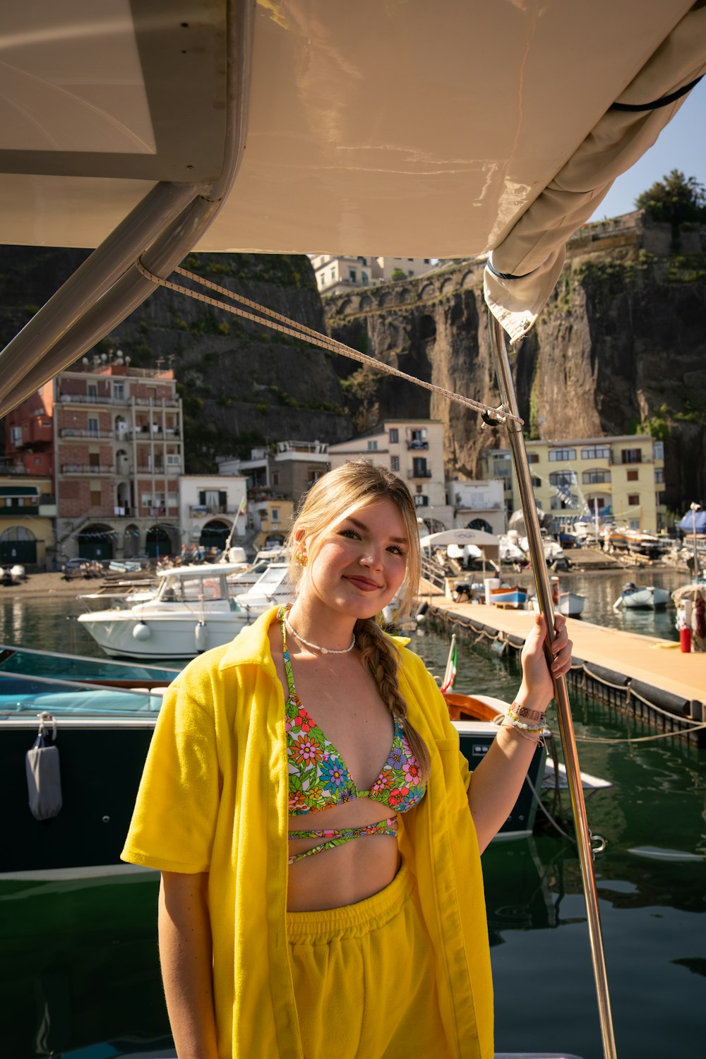 a woman standing on a boat holding a pole