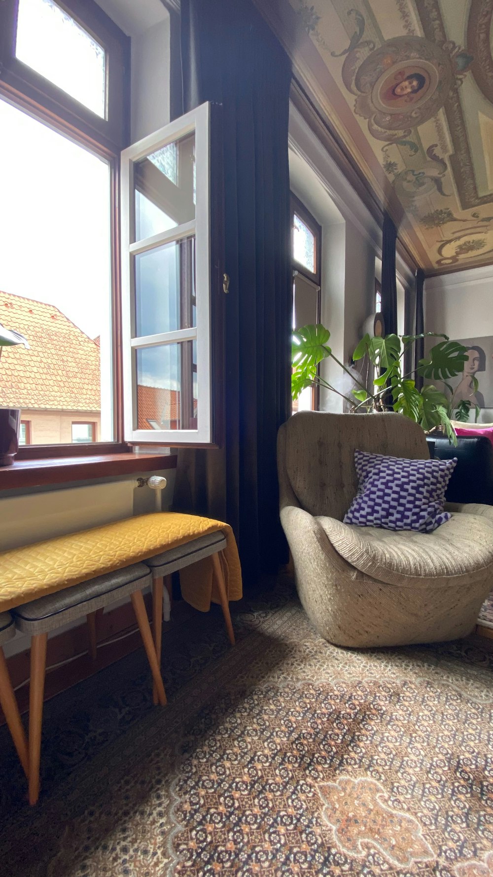 a living room filled with furniture and a large window