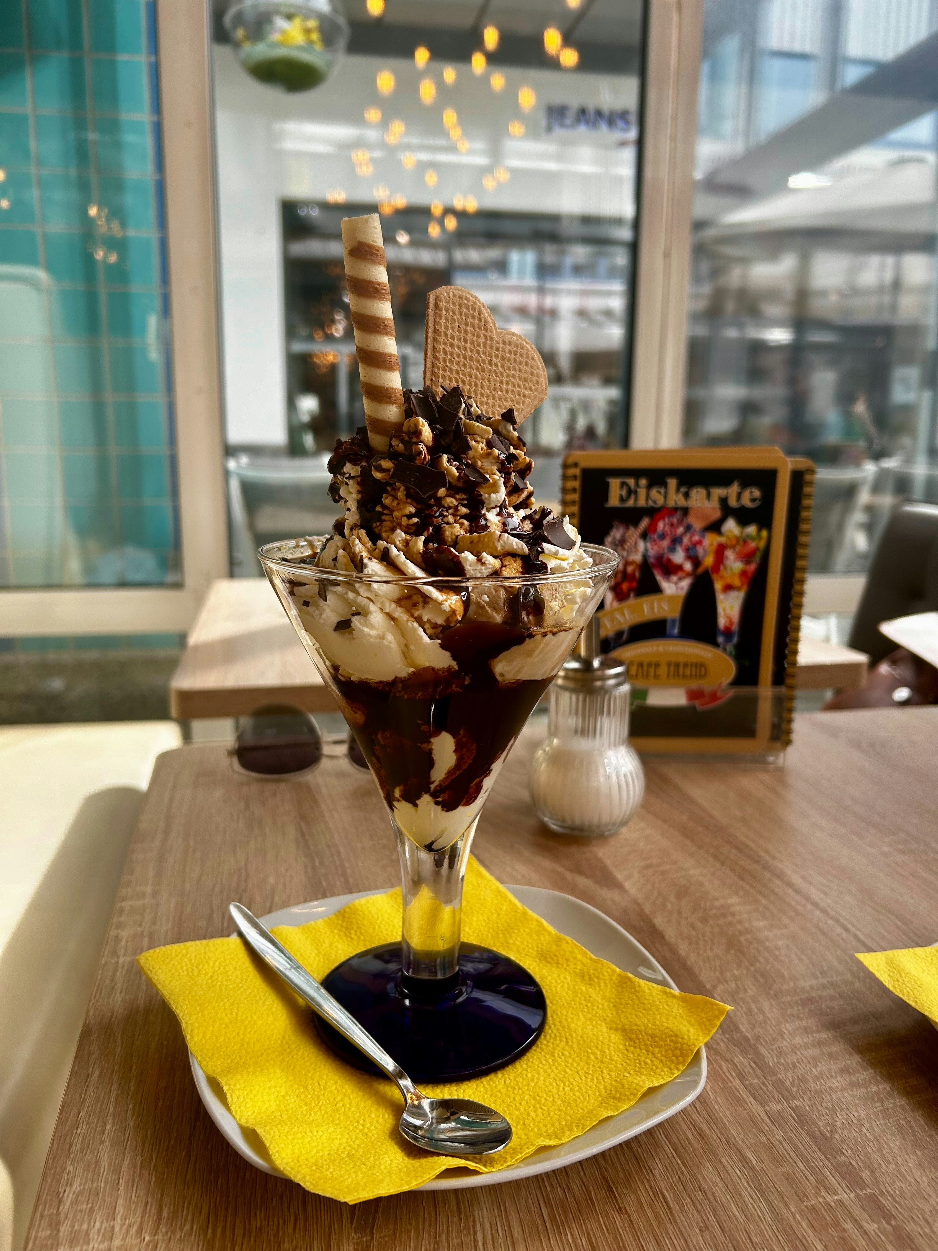 An ice cream sundae on a table in a restaurant photo – Free Food Image ...