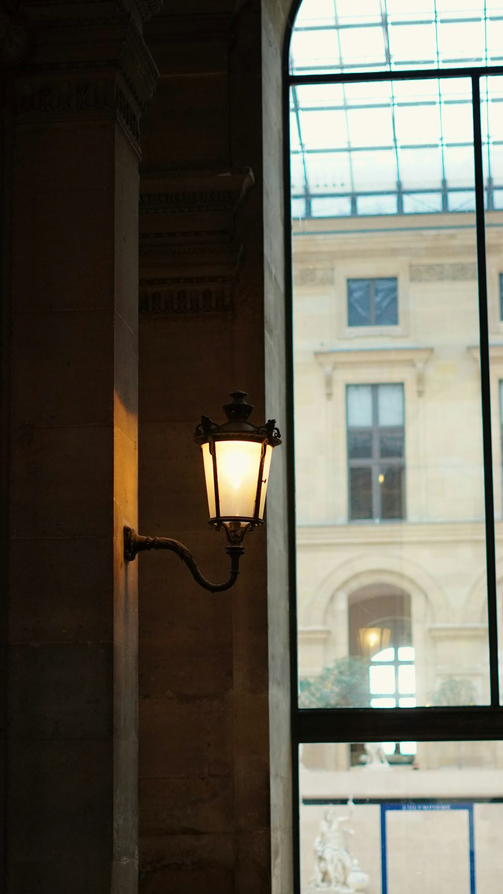 a street light in front of a large window