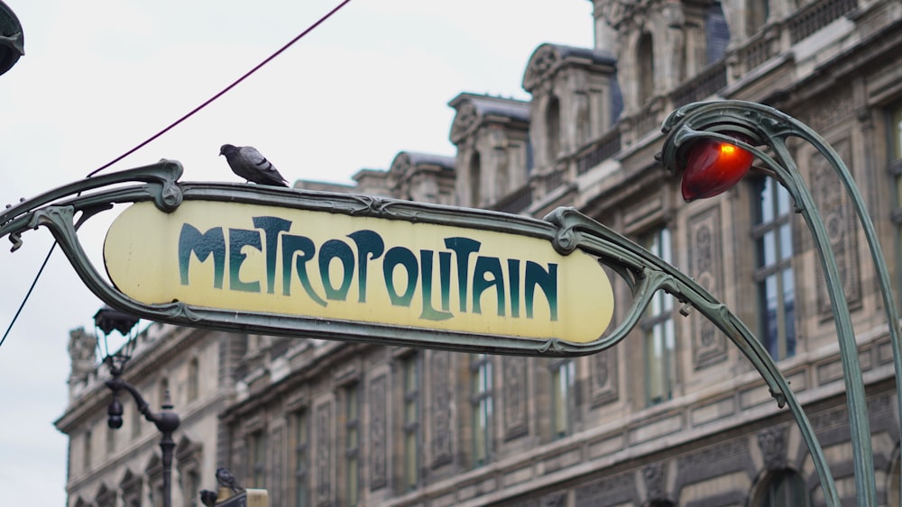 a street sign hanging from the side of a building