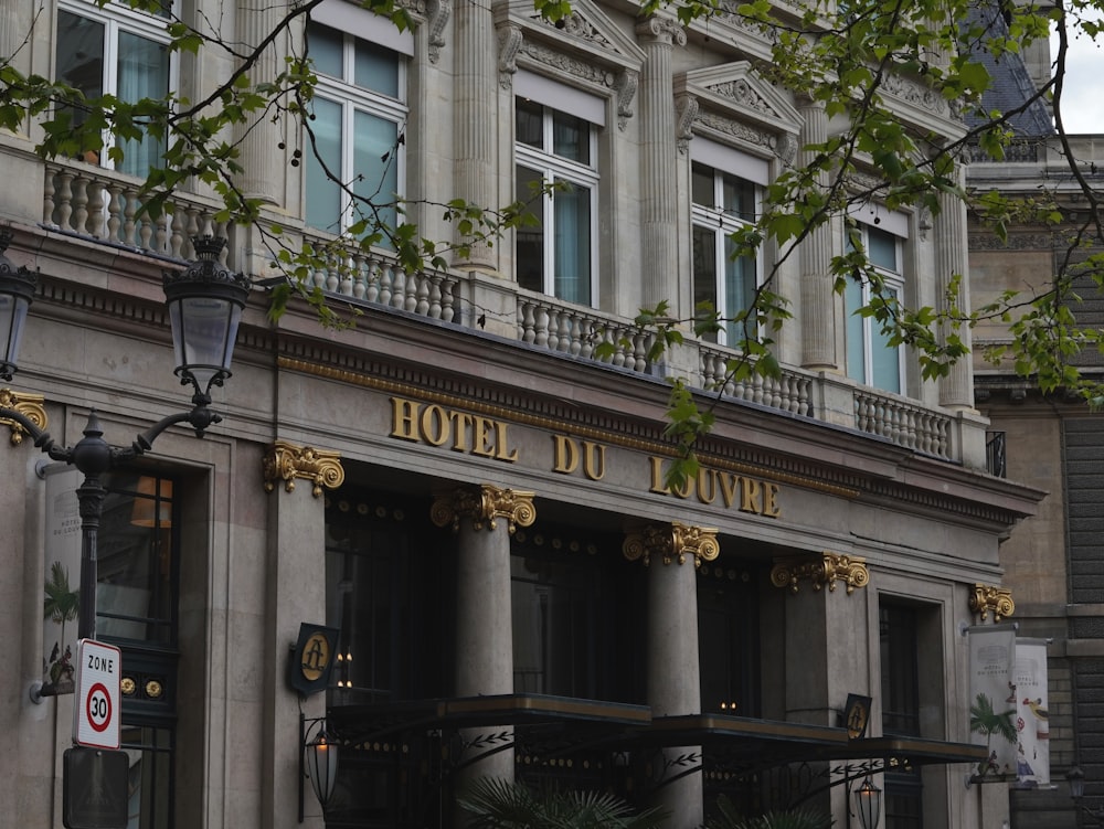 a hotel with a clock on the front of it